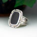 3/4 left view, cushion black onyx gemstone bezel set bead wire and stamped cutout wire accent on tapered wide band